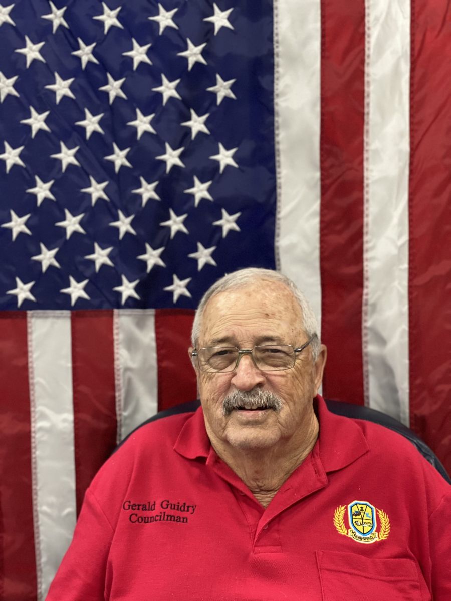 council member in front of American flag