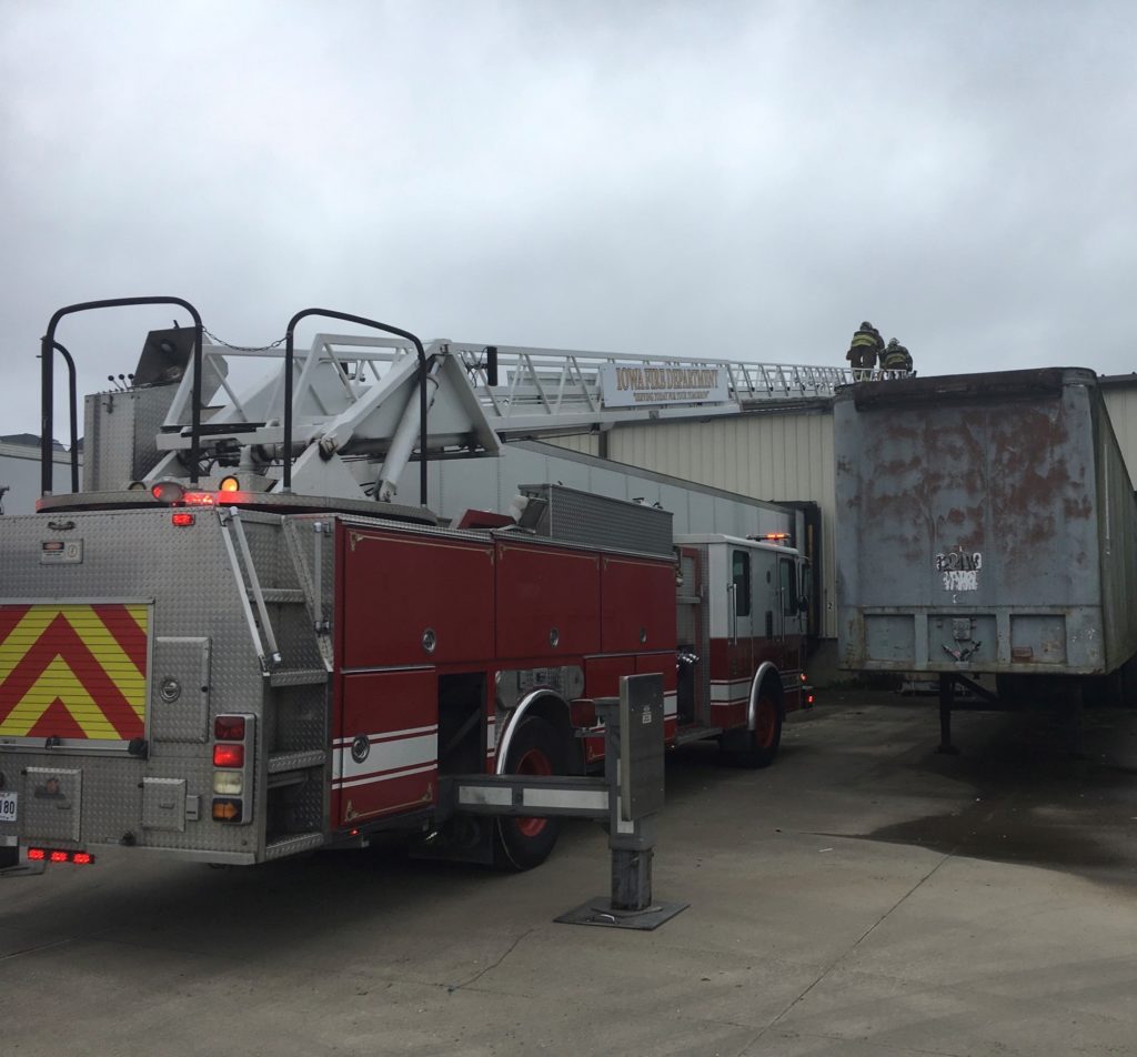 men on fire truck ladder